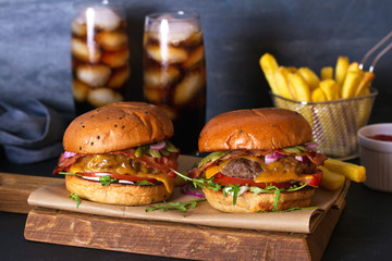 Beef burgers and french fries on serving board. Street food, fast food