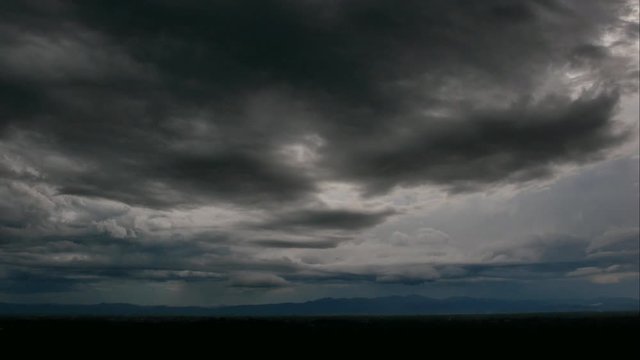 Time-lapse of The dark expanse of the sky, a huge and, foretelling the arrival of a big, stormy rain and thunderstorm. This atmospheric display adds a dramatic touch to the natural environment.