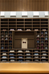 Brown wooden stand with men's shirts, ties in the store 