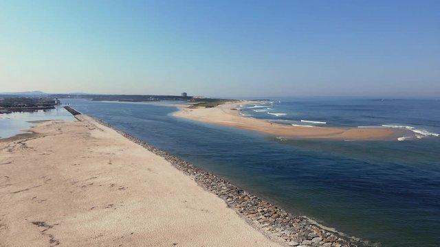 DRONE The two sides of Restinga de Ofir. One facing the ocean, the other the estuary of C&aacute;vado River. The jetty structure that protects the coastline from the currents and tides in Esposende, Portugal