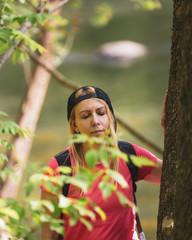 A woman connects to nature by feeling the energy of a tree