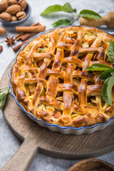 Apple pie with lattice top on wooden background, table top view. Rustic american cusine cake