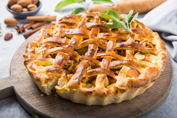 Apple pie with lattice top on wooden background, table top view. Rustic american cusine cake
