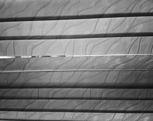 Black & white horizontal blinds with slit background
