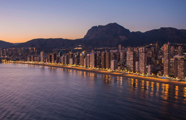 Night city by the sea with an empty beach and beautiful night lighting, Summer background