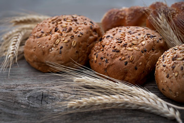 fresh buns with whole grains on a wooden table