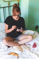 young woman taking a photo at home