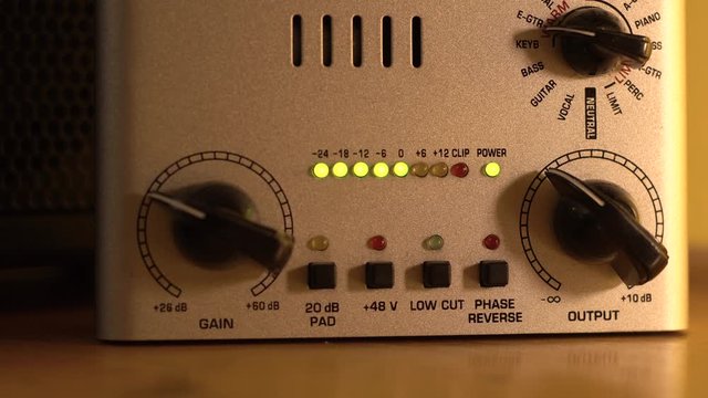 Indication lights illuminate the preamp for musical instrument instruments and indicate the sound level. Selective focus close up.