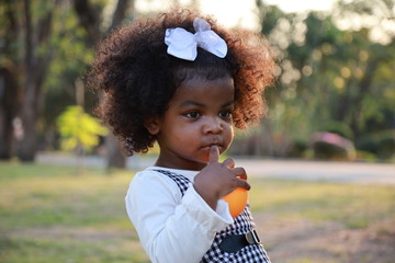 Portrait of Cute kid hand holding a ball at the garden