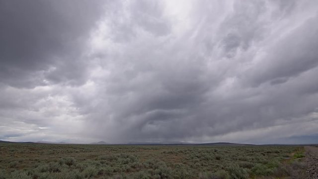 Time lapse of storm clouds moving over the Idaho landscape over field of sagebrush.