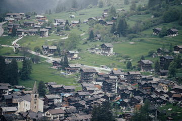 Fototapeta na wymiar Village in the Swiss mountains. View from above.