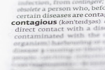 Fototapeta premium Definition of the word contagious on a dictionary page 