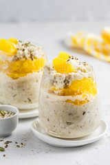 Orange oatmeal breakfast in glasses. Slective focus, copy space.