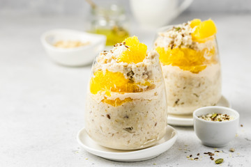 Honey citrus oatmeal breakfast dessert  in glasses. Slective focus, copy space.