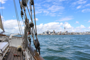 View of Auckland skyline from the Ted Ashby sailing boat (Maritime Museum) in Auckland harbour, New...
