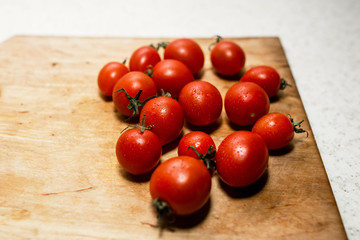 cherry tomatoes many near beautifully on a wooden board