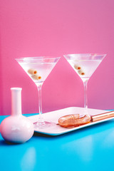 Extra dry martini, classic cocktail with olives, vodka and gin served cold.  New modern cockails drinks design concept