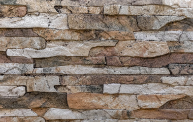 hand cut stone wall close up, rough texture pattern background