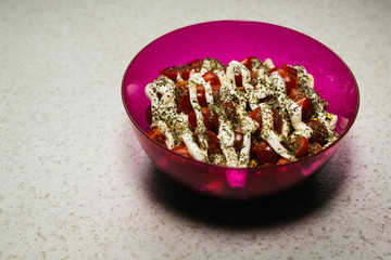 caesar salad in a purple bowl with mayonnaise