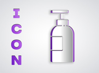 Paper cut Hand sanitizer bottle icon isolated on grey background. Disinfection concept. Washing gel. Alcohol bottle for hygiene. Paper art style. Vector Illustration.