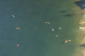 people practicing Stand up Paddle on the red beach seen from the top of Morro da Urca in Rio de Janeiro.