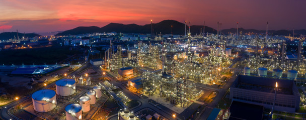 Aerial view. Oil refinery factory and oil storage tank at twilight. Petrochemical Industrial. Banner panorama background
