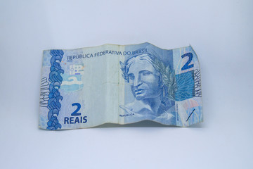 Two reais banknote (Brazilian currency) on a white background