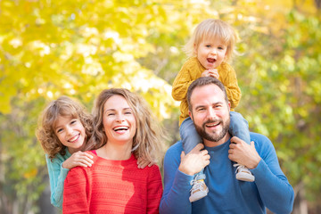 Happy family having fun outdoor in autumn park
