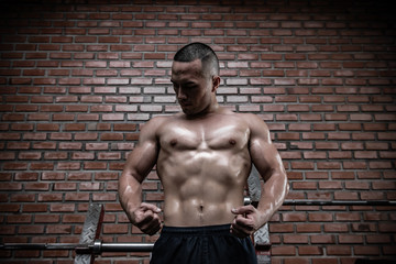 Fototapeta premium Portrait of asian man big muscle at the gym,Thailand people,Workout for good healthy,Body weight training,Fitness at the gym concept