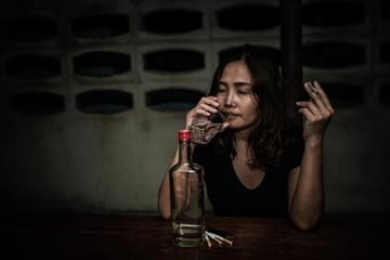 Asian woman drink vodka alone at home on night time,Thailand people,Stress woman drunk concept