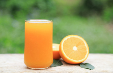 orange juice with fruit on wooden table 