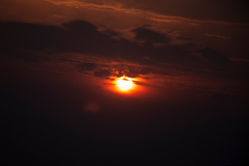 Cloudy sky golden sunlight, sun behind the clouds