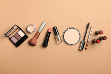 Different makeup cosmetics on brown background. Female accessories