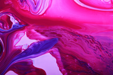 Colorful marble background.Mixed nail polishes-pink and navy blue.Beautiful stains of liquid nail...