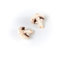 Fototapeta na wymiar Fresh champignon mushroom cut in two halves on a white background