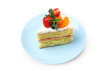 Plate with berry cream cake isolated on white background