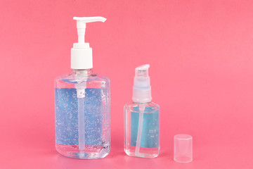 pump bottle of hand sanitizer  prevent the spread of infection like corona virus on a pink background