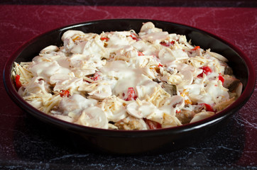 Meat casserole with vegetables and mushrooms close-up. Cooking process. Homemade stew in the pan.