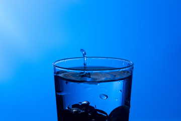water falling into a clear glass