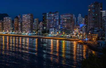 Obraz premium Night city by the sea with an empty beach and beautiful night lighting, Summer background