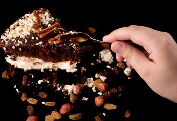 Hand eats a piece of cake