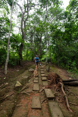 Obraz premium Visitor with dog on the trail at Puganyo Petrified Forest, Ecuador