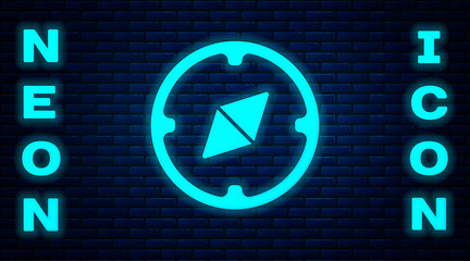 Glowing neon Compass icon isolated on brick wall background. Windrose navigation symbol. Wind rose sign. Vector Illustration.