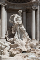 Detail of Oceanus on the famous Trevi Fountain, a major tourist attraction in Rome. The giant statue stands in front of a classical colonnade in the centre the fountain.