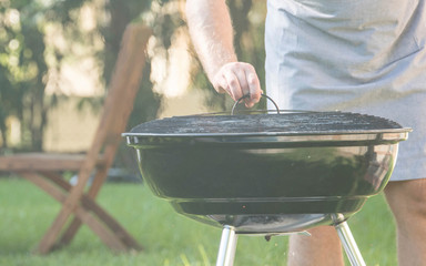 Summertime fun. Barbecue for summer family dinner in the backyard of the house.