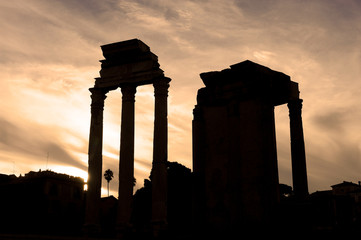 Roman ruins and backlit columns at sunset in the Roman Forum in Rome Italy