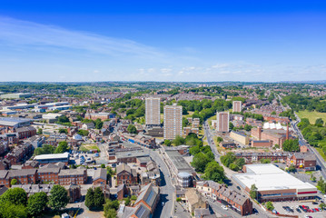 Fototapeta na wymiar Aerial photo of the town centre of Armley in Leeds West Yorkshire on a bright sunny summers day showing apartment blocks flats and main roads going in to the town