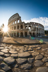 Fototapeta na wymiar Colosseum or Coliseum in Rome and morning sun, and roman stones, Italy, Europe