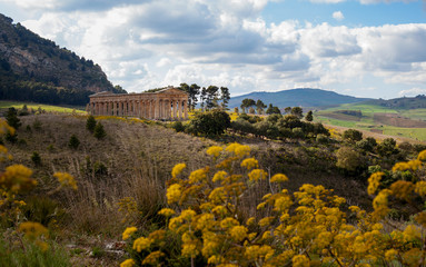 A view across the Sicilian landscape towards the ancient temple at Segesta, build in a Classical...