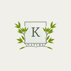 Green eco letters K logo with leaves in square shape. Initials with botanical elements with floral letter design for business identity style